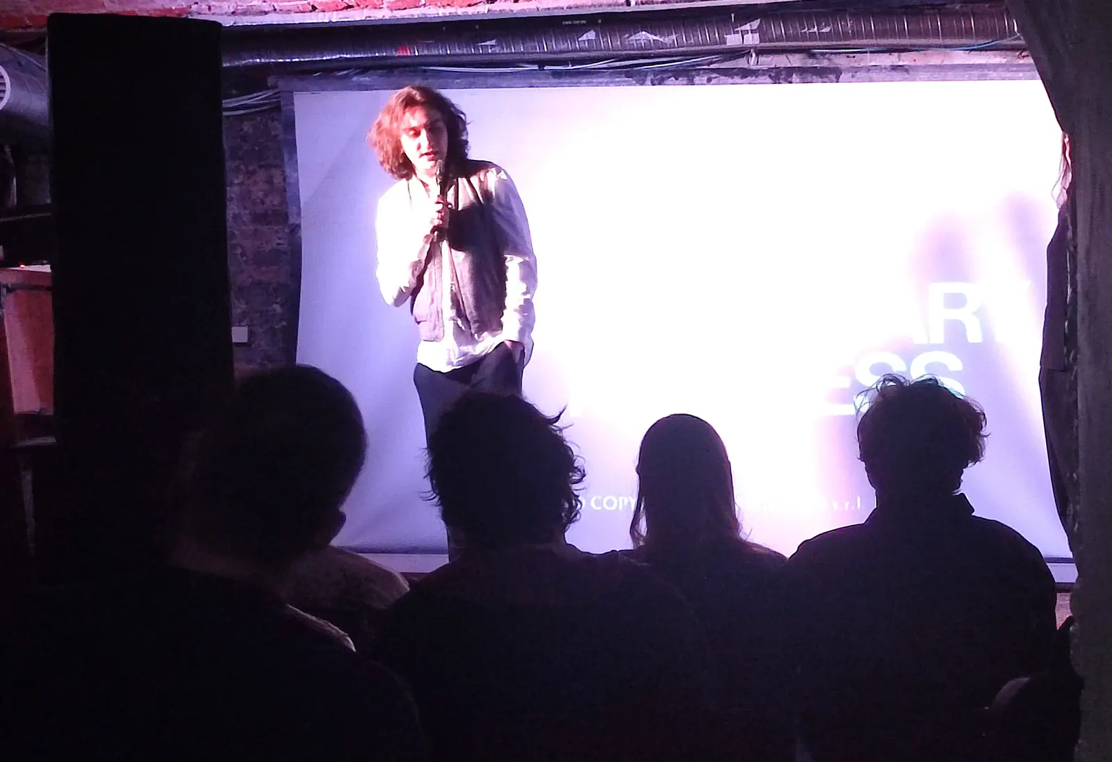 A speaker addressing the audience on stage during the 2025 event.